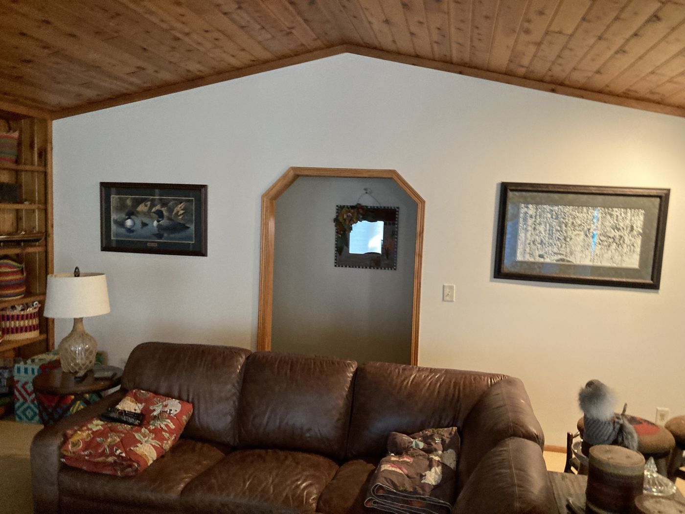 Same wall finished in light gray with art rehung