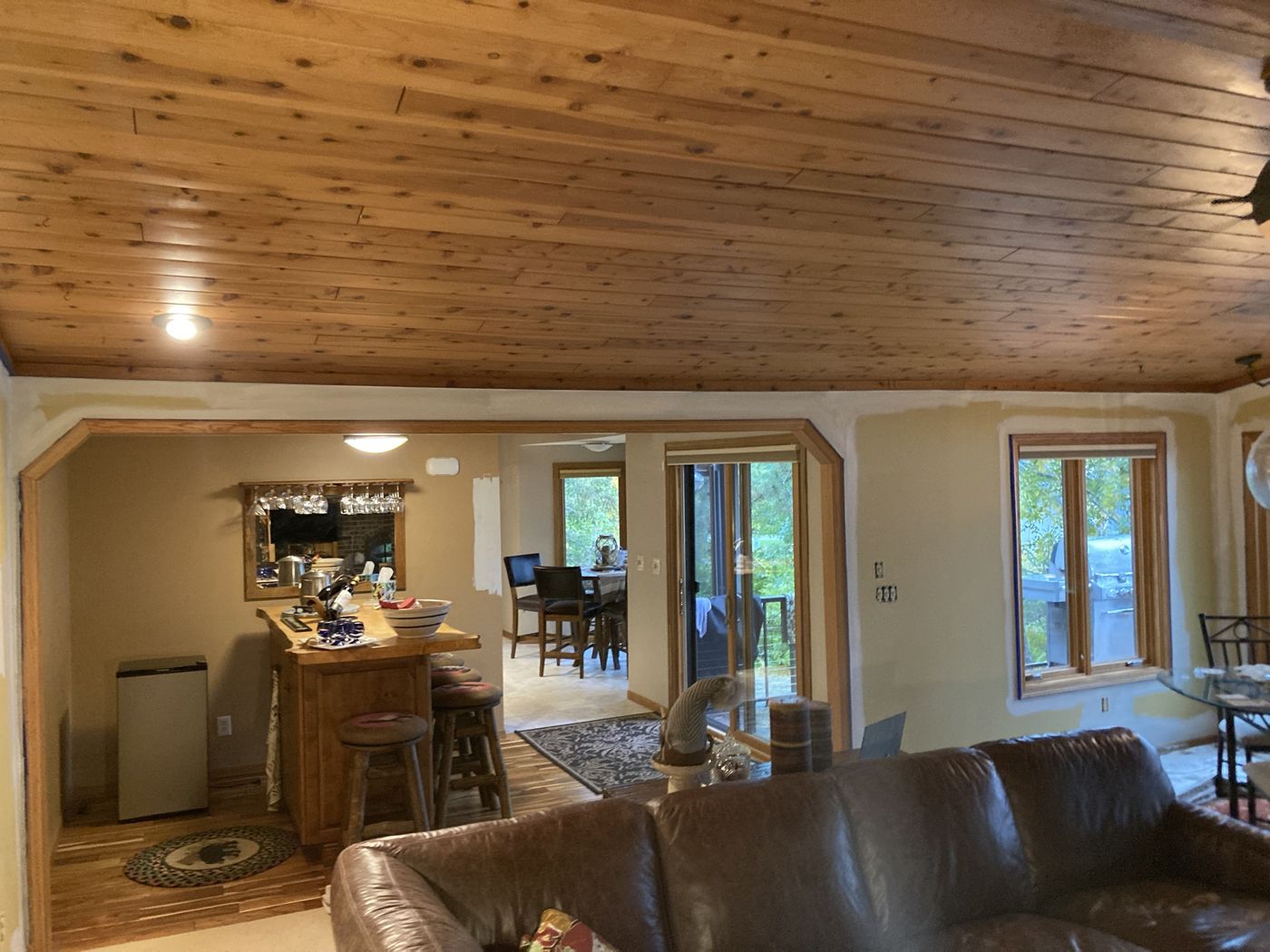Room with walls cut in along the pine ceiling and around the windows