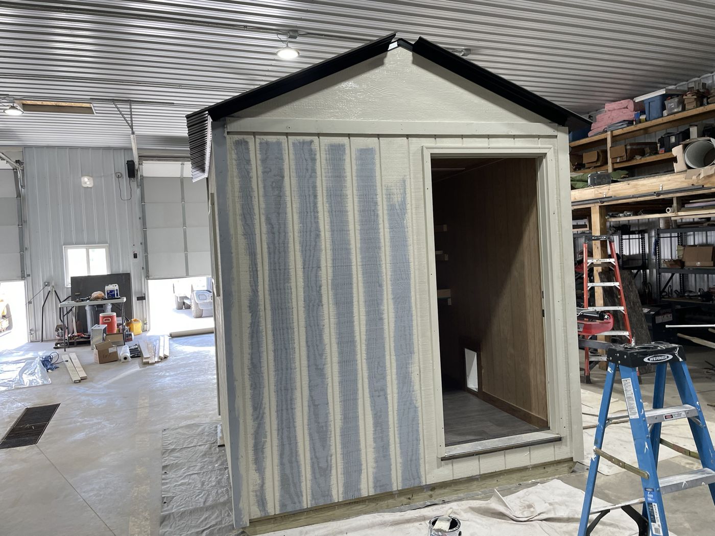 Shed siding mid-coat with paint brushed into the grain